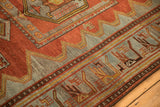 Lightning serrated main field and geometric animal border on a distressed vintage Persian rug.