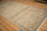 Angled view of a distressed Peshawar runner's even wear and soft, neutral-toned pattern.