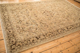Distressed, low pile texture and chocolate brown floral border on a vintage Arak carpet.