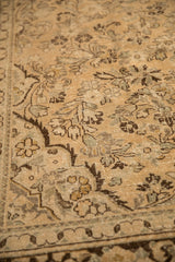 Visible knot heads and low pile texture of a vintage Arak carpet's floral design.