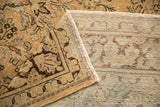 Folded corner of the vintage Arak rug showing the distressed low pile and hand-knotted foundation.