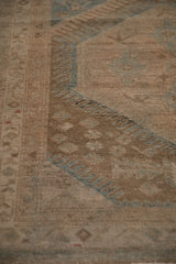 The distressed texture and even wear to the knot heads on a vintage Persian Malayer runner.