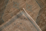 Corner detail of a distressed Persian rug showing the intact side cord and low pile worn to the knot heads.