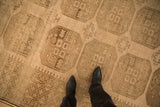Close view of the even, low-pile texture and geometric guls on a distressed Ersari carpet.