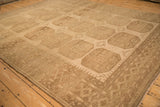 Angled view of a vintage Ersari carpet showing its distressed, low pile and geometric gul pattern.