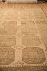 Low angle view showing the even wear and columns of geometric guls on a vintage Ersari rug.