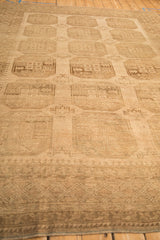 Angled perspective on a vintage Ersari carpet, detailing its worn low pile and geometric guls.