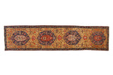 Antique Karabagh runner with geometric shield medallions in blue and red over a unique gold field.