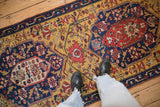 A view from above showing the scale and vibrant geometric patterns of an antique Karabagh runner.
