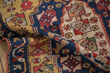 A close-up of an antique Karabagh runner's hand-knotted pile, folded to show its texture.
