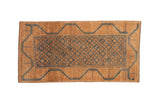 Vintage distressed Belouch rug runner with a geometric trellis pattern in sapphire blue and terracotta orange.
