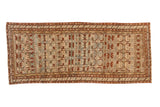 Antique distressed Borchalou rug runner with geometric floral blossoms in sand, burgundy red, and teal.