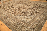The decorative floral pattern of a distressed Kaboutrahang carpet in coffee brown and platinum.