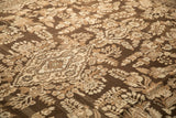 Angled view of floral sprays in silver and coffee brown on a distressed Kaboutrahang carpet.