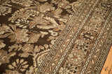 Close-up of the distressed Kaboutrahang's low pile with floral patterns in coffee brown and platinum.