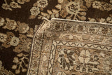 Hand-knotted back and machine-bound edge of a vintage chocolate brown Persian carpet.
