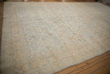 Angled view of a distressed Agra carpet's powder blue and lemon gold Herati design.