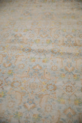 Angled detail of the soft, distressed cotton pile showing powder blue and lemon gold Herati motifs.
