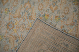 Hand-knotted foundation and secured powder blue side cord of a vintage distressed Agra carpet.
