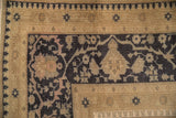 Geometric cartouche border in sand and cobalt blue on a distressed vintage Oushak carpet.
