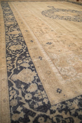 Angled view of a distressed Oushak carpet showing mostly even wear across the knot heads.