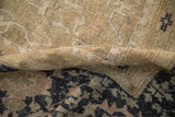 Close-up of a distressed Oushak carpet showing wear to the knot heads and visible foundation.