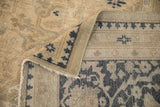 Reverse side of a vintage Oushak carpet showing the hand-knotted foundation and secured edge.