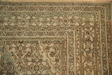 Corner view of the intricate turtle samovar border on a low-pile vintage Persian rug.