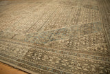 Angled close-up of the distressed low pile, showing dusty teal abrash and turtle border motifs.