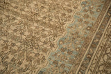 Detail of the turtle samovar border in dusty teal contrasting with the worn camel Herati field.