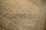 Close detail of the turtle samovar main border and distressed Herati field in camel and dusty blue.