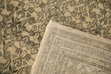 The back of the vintage rug reveals its hand-knotted weave next to the distressed, low-pile front.
