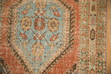 Close-up of the distressed weave on the red serpent border and powder blue medallion.