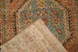 The back of a vintage Persian runner revealing the hand-knotted weave and worn pile.