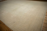 Low pile and storied patina on a distressed Mir Sarouk carpet, seen from a long angle.