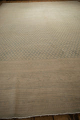 Low-pile texture on a distressed Sarouk showing the faint foundation beneath slate botehs.