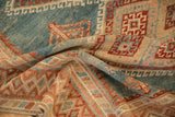 Soft folds of a vintage Malayer rug showing the worn, low-pile texture and geometric patterns.