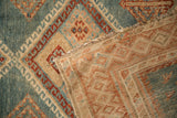 A folded corner of the vintage Malayer rug reveals its hand-knotted foundation.