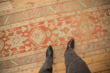 Evenly worn pile on a vintage Heriz rug runner with terracotta and powder blue medallions.