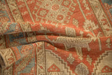 Folded vintage Heriz rug highlighting its time-worn texture and low-knotted pile.