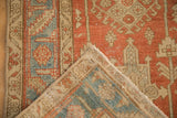 Corner of a vintage Heriz runner folded back to reveal the hand-knotted foundation.