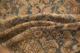 Softly folded vintage Malayer runner showing the distressed, hand-knotted weave and time-softened colors.