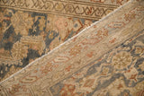 Detail of the vintage Malayer rug's back, showing the hand-knotted weave and restored side cord.