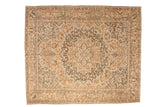 Vintage distressed Bakhtiari carpet with a concentric floral medallion in dusty teal, camel, and sand.