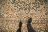 Evenly worn low pile texture of a vintage distressed Bakhtiari rug in teal and sand.
