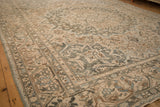 Low perspective across a distressed Bakhtiari carpet showing its low pile and floral border.