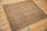 Full view of a vintage Karaja rug with a time-worn patina on its red and green geometric design.