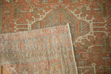 A corner of the distressed Karaja rug is folded back to reveal the hand-knotted weave.