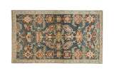 Distressed Persian Malayer rug with large-scale floral motifs in rust, gold, and powder blue.
