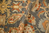 A folded view of the distressed Malayer rug highlighting its soft pile and serrated leaf designs.
